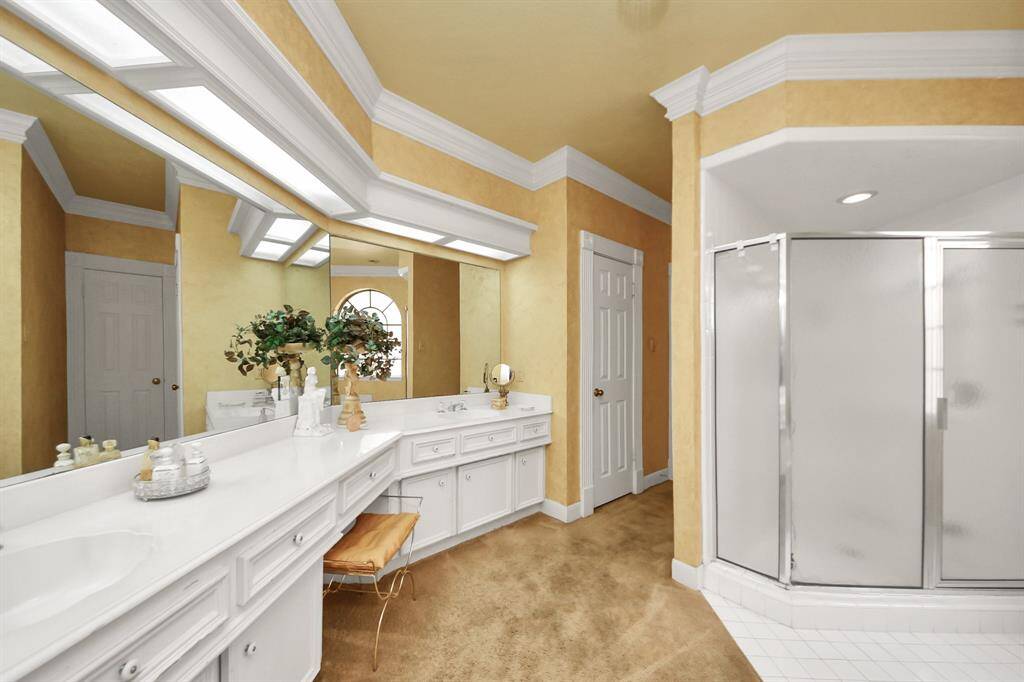 The primary bath is a blank canvas, ready for your spa-like transformation! It features a large walk-in shower, soaking tub, and double sinks—offering both space and potential.
