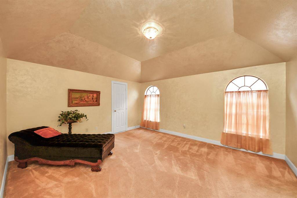 One of five secondary bedrooms upstairs. This room features a walk-in closet plus a floored attic space for all your storage needs.