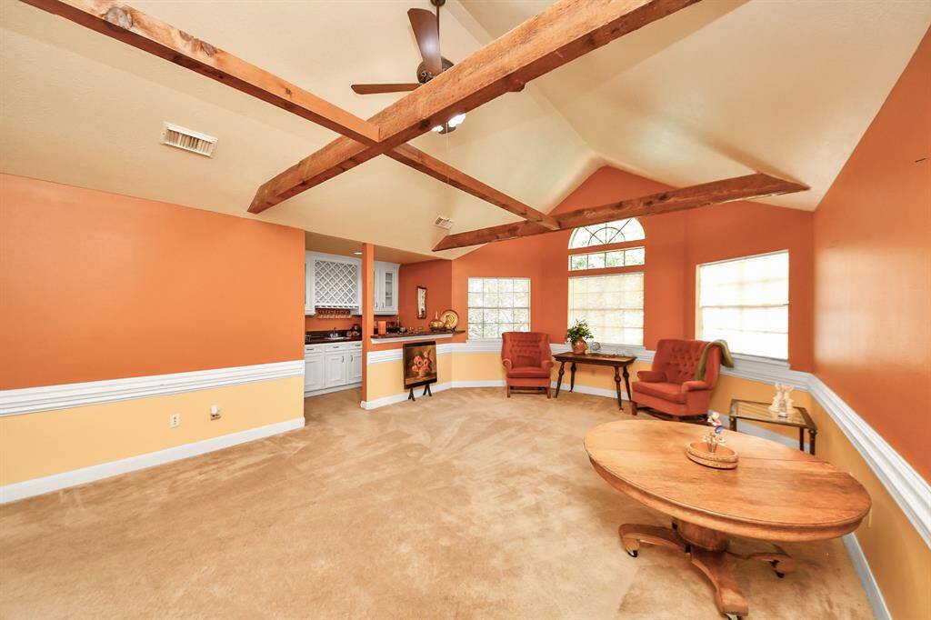 Check out this incredible game room featuring soaring ceilings and charming rustic beams—perfect for fun and relaxation!