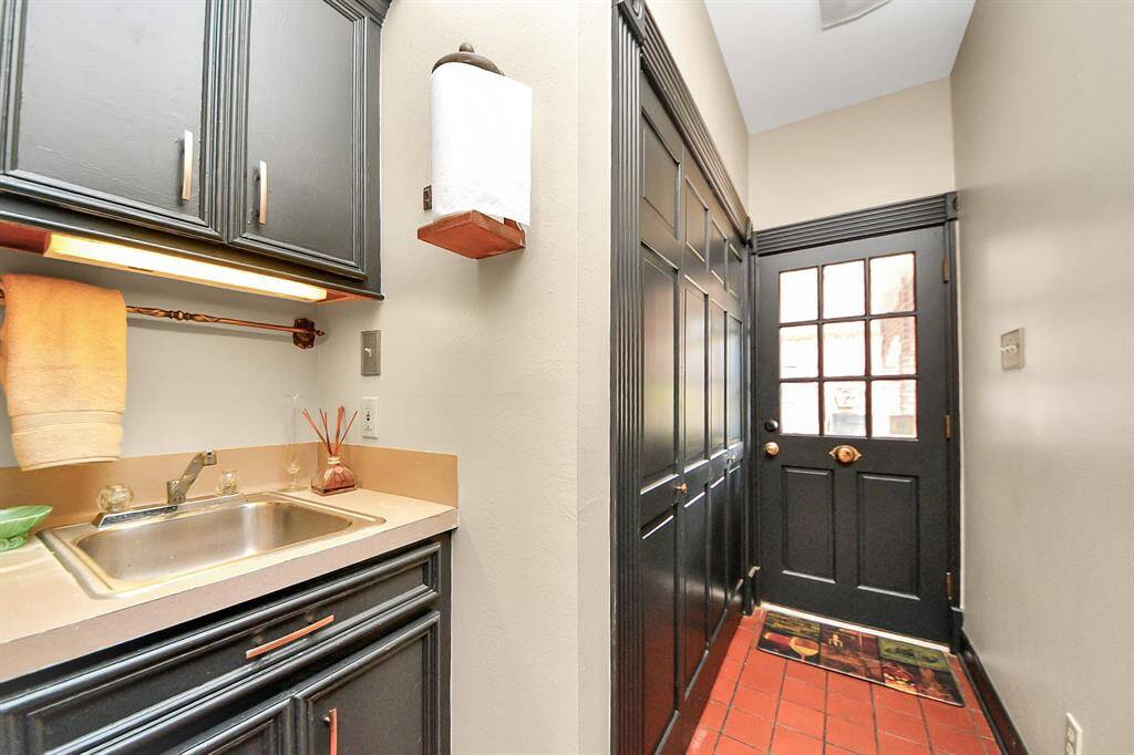 The laundry room offers under cabinet lighting and a great utility sink! The home is sold with a top loading HE washer and front load Maytag dryer. This laundry room is located on the first floor.