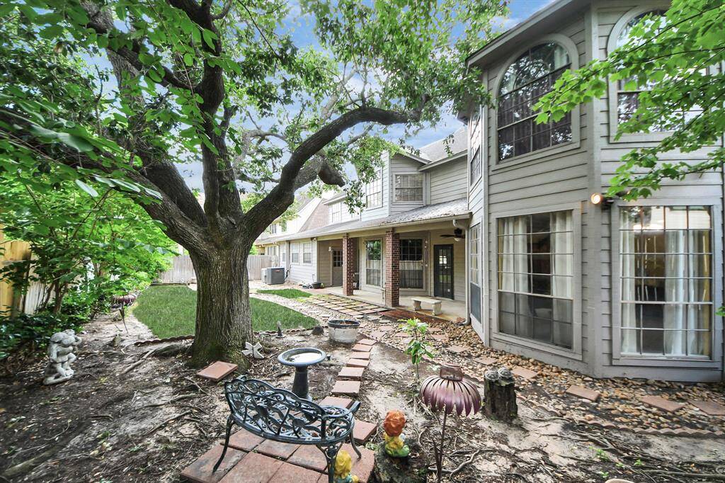 The backyard offers a recently installed fence, a covered patio, and a charming spot perfect for gardening. Enjoy the mature trees and minimal grass upkeep!