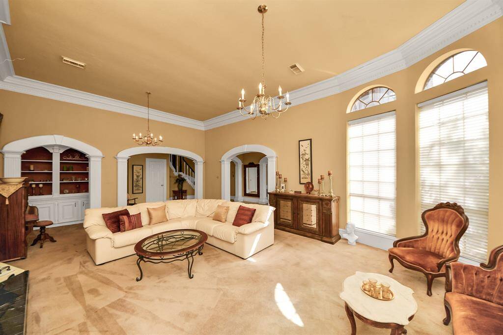 Floor to ceiling windows offer an abundance of natural light to this spacious family room.