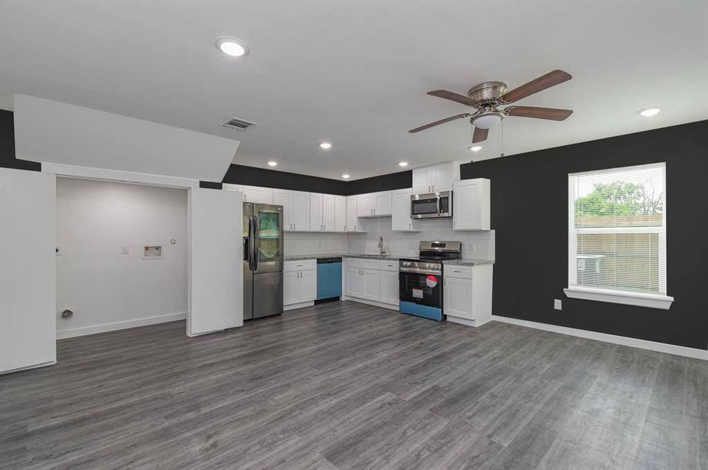 living room overlooking kitchen, dining area and laundry room