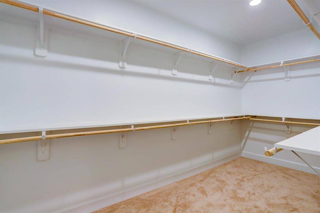 Spacious walk-in pantry with plenty of shelving to keep your kitchen essentials organized and within reach.