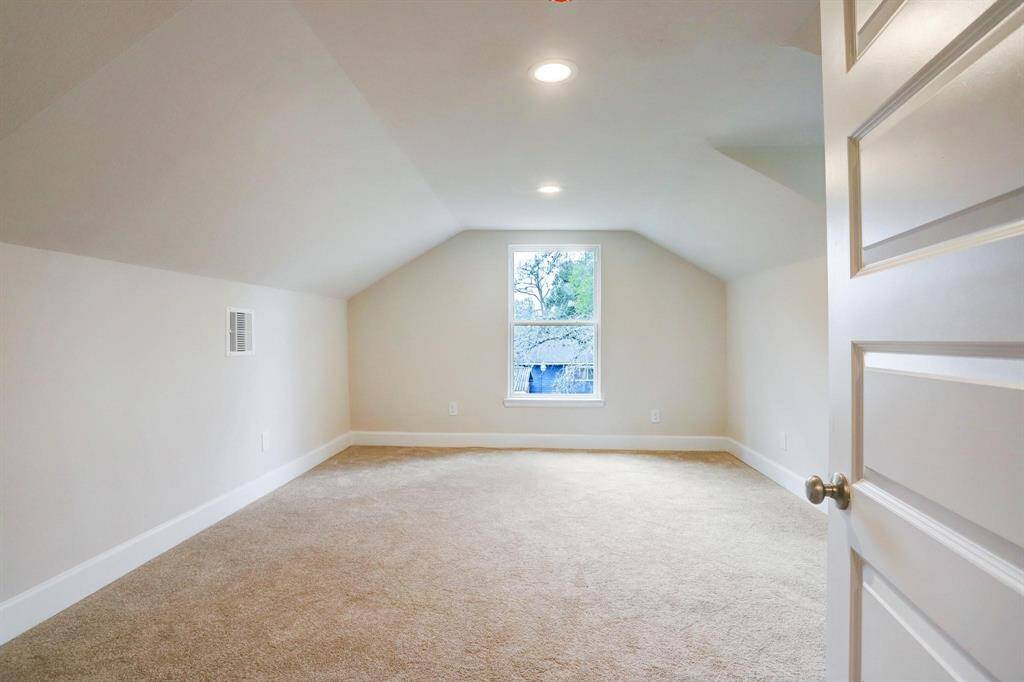 Second upstairs bedroom with natural light and dormer space ideal for closet storage or study area.