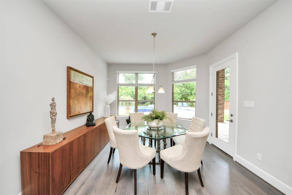 The breakfast room has ample natural light with large windows and overlooks the gorgeous backyard.