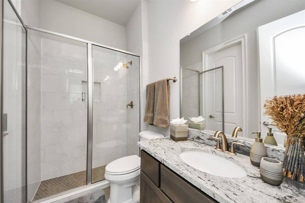 En-Suite Bath for the first floor secondary bedroom  has a convenient walk-in shower, ideal for accommodating elderly guests.
