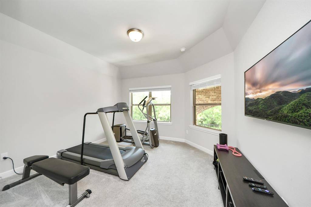 A secondary bedroom off of the game room.  This bedroom overlooks the gorgeous backyard.