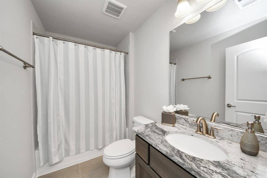 En-Suite Bathroom with a tub and granite countertop.