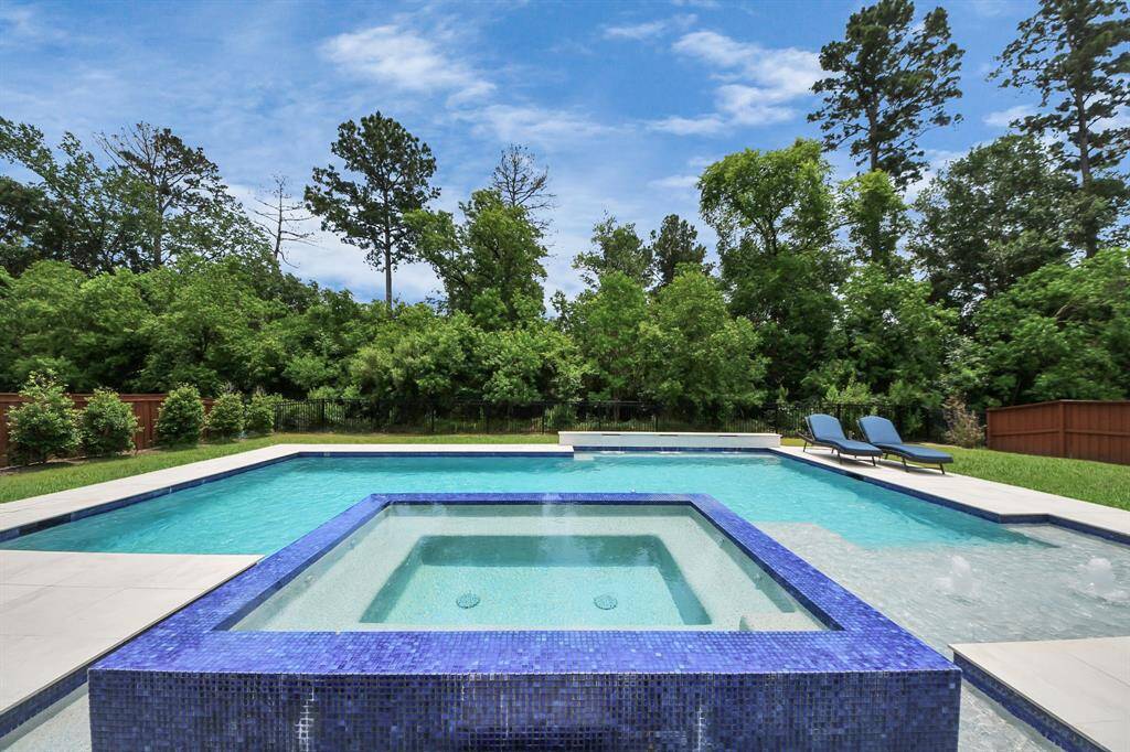 The ultimate backyard oasis with a stunning 90,000  dollars custom resort-style pool, perfect for relaxation and year-round entertaining.