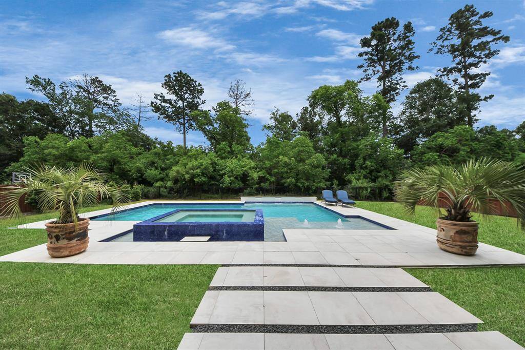 Surrounded by lush greenery and no back neighbors, this pool area is more than just a place to swim.