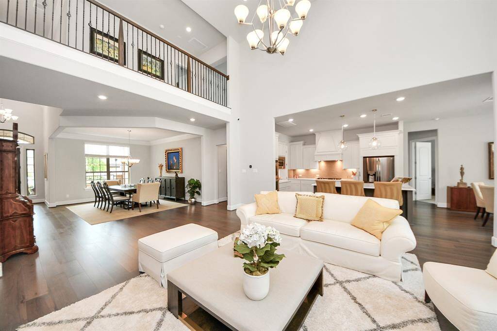 Experience the grandeur of a two-story ceiling with stunning views of the resort-style backyard and its beautiful pool.