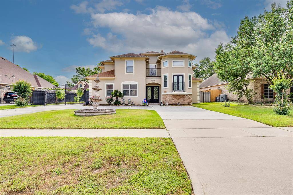 Huge driveway extends into the backyard—perfect for extra parking, trailers, or easy access to outdoor spaces.