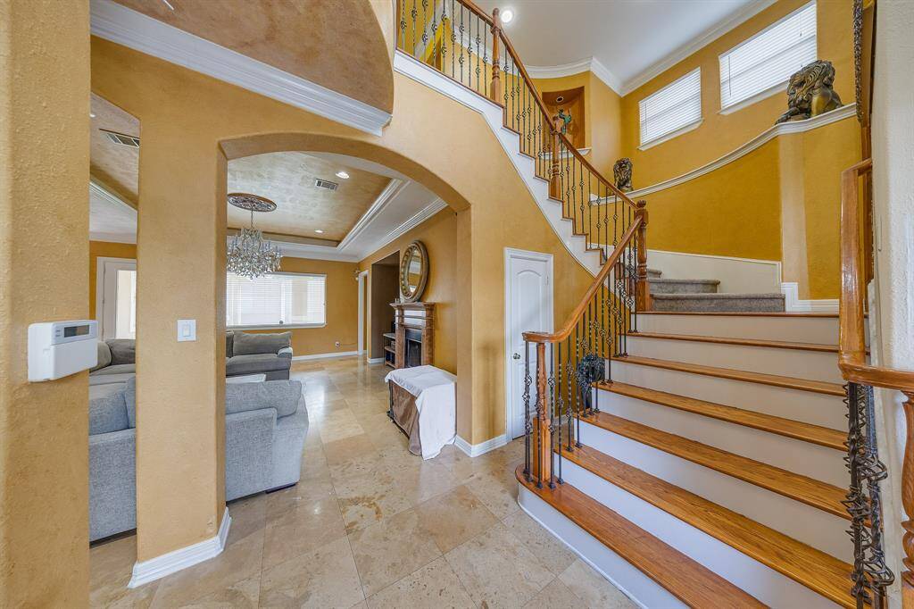 Large accent stairs with charming details, creating a fairytale-like entrance that adds elegance and character to the home.