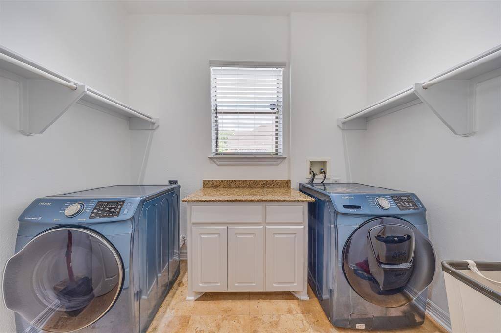Spacious utility room with washer and dryer connections, offering practical space for laundry and household tasks.