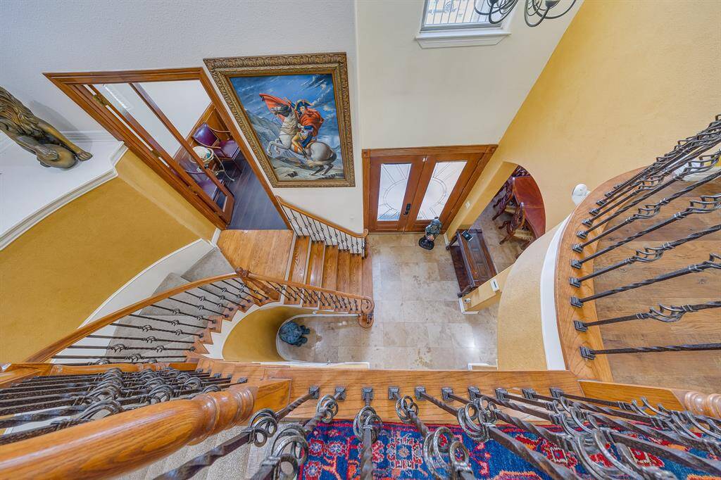 Accent stairs leading from above, creating a grand entrance to warmly greet visitors as they arrive.