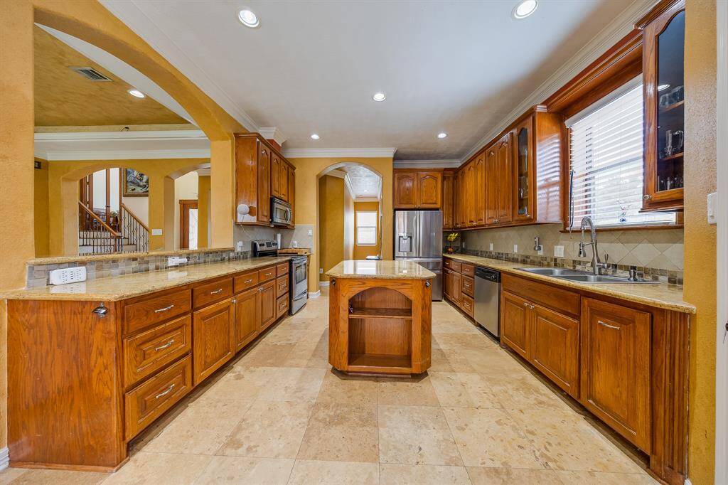 Expansive kitchen with ample counter space, modern appliances, and open layout—ideal for cooking and gathering.