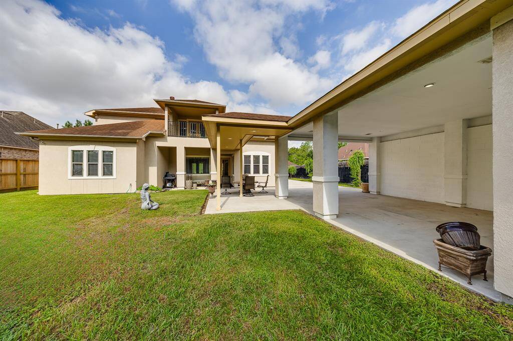 Rear carport attached to the garage, offering extra covered parking and convenient access to the home.
