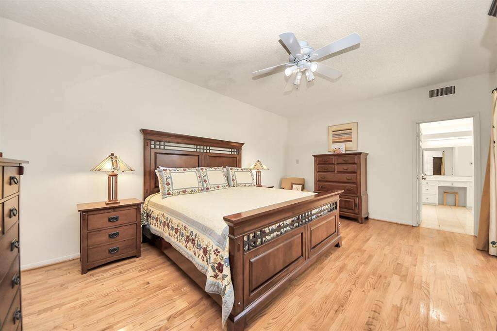 Enormous primary suite downstairs has flexibility for additional seating arrangements or various furniture placement.