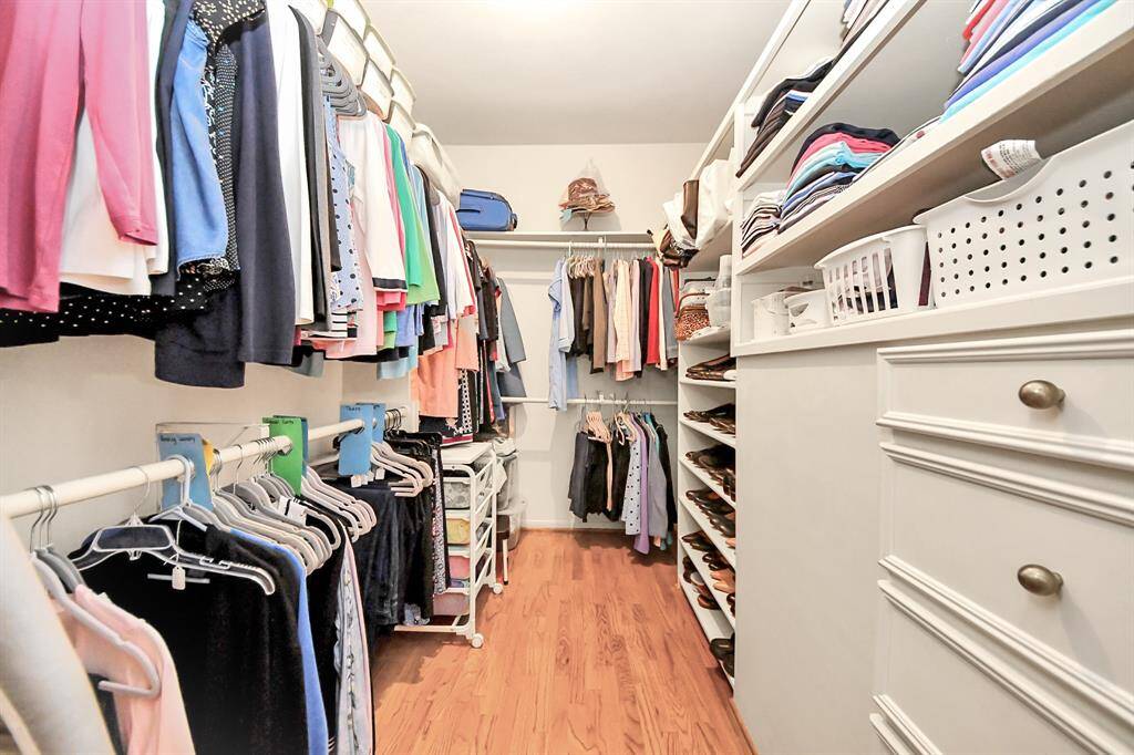 Separate walk in closets with built in cabinets and valet drawers offer plenty of space to get organized.