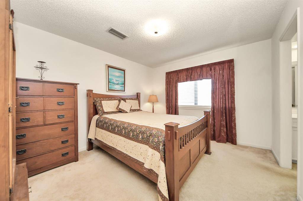 Guest bedroom upstairs overlooks the side yard/neighboring house.