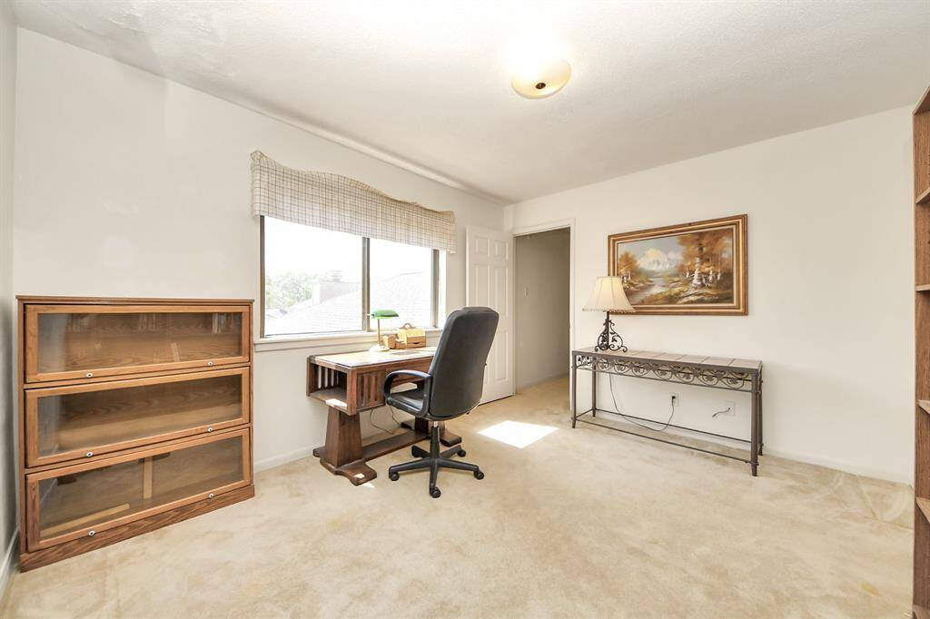 Another guest bedroom upstairs overlooks the beautiful backyard.