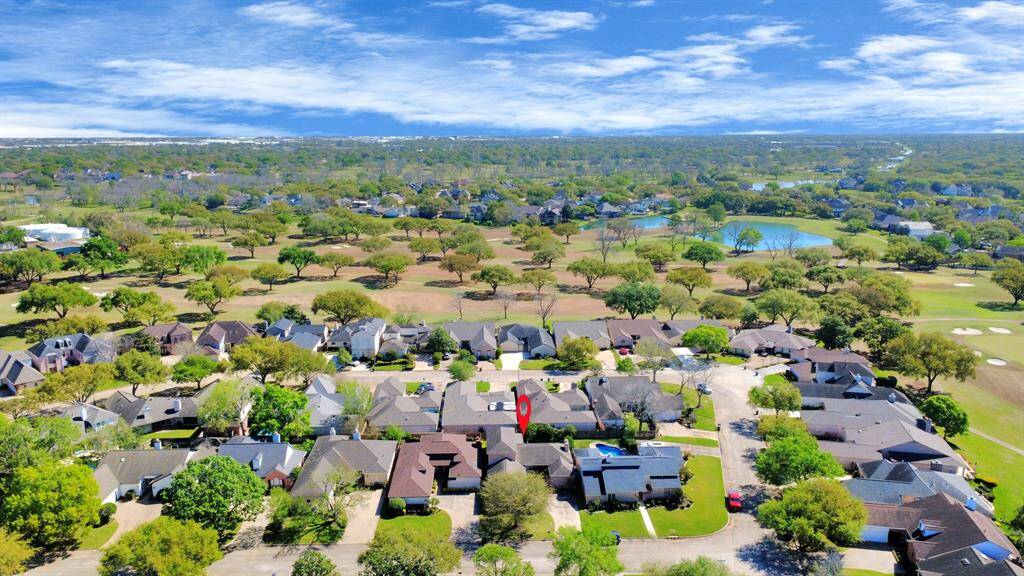 Aerial view shows proximity to the golf course and multiple green spaces throughout the community.