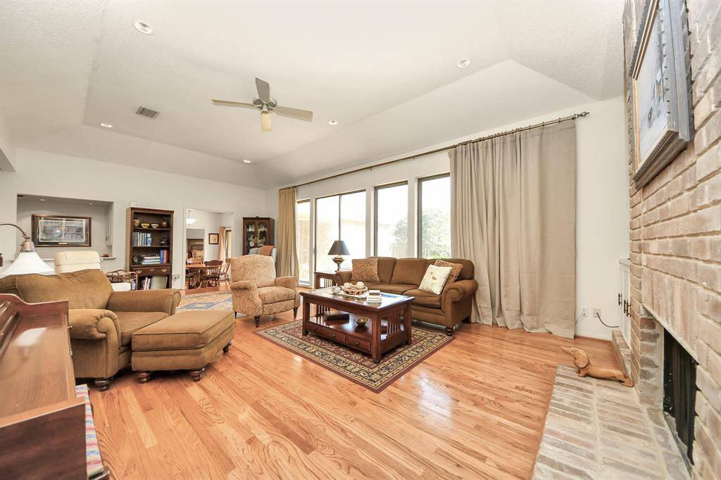 Rich wood floors gleam in the sunlight. Huge picture windows bring in spectacular light.