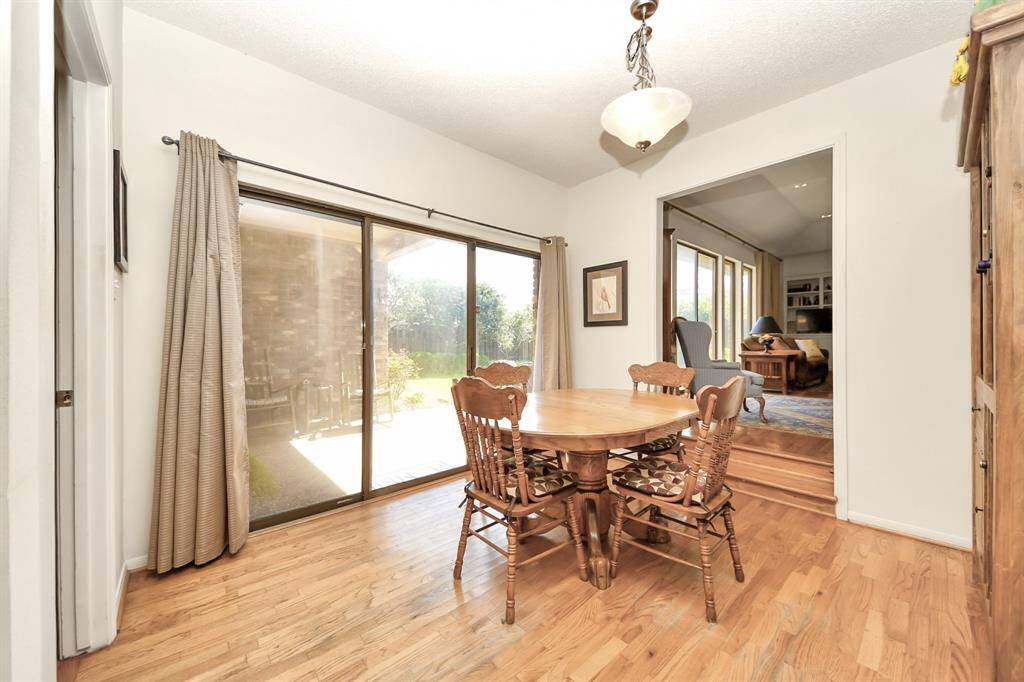 Cheerful breakfast room features walk out patio access to covered space overlooking the gorgeous backyard.