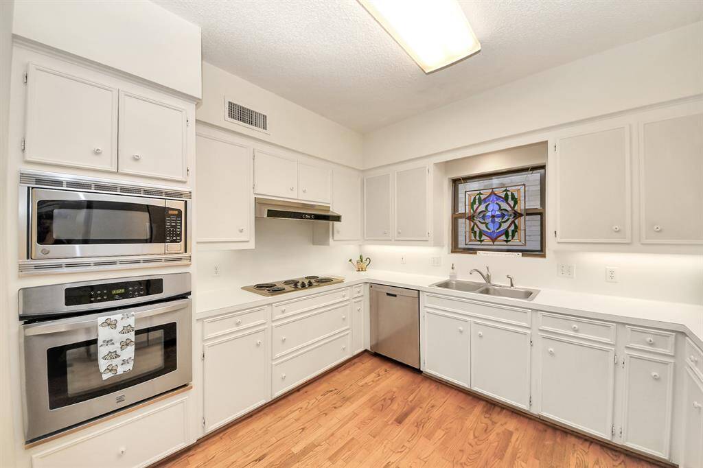 Thoughtfully designed kitchen has been updated with stainless appliances. Stunning wood floors are a beautiful addition.