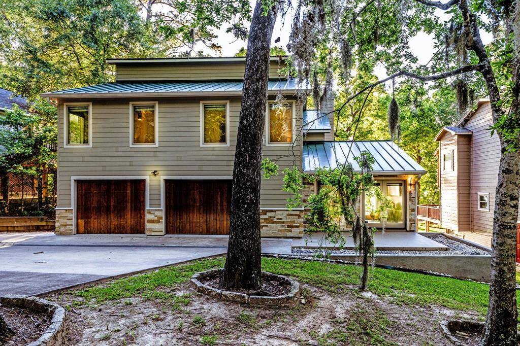 Modern lakefront living at its finest - this sleek, tree framed home blends natural charm with a contemporary design only steps away from your unique sandy beach on the shores of Lake Livingston.