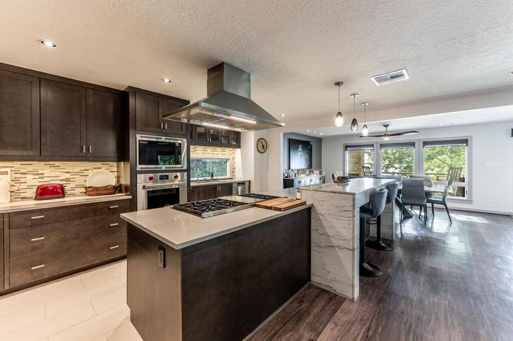 With custom cabinetry, granite and quartzite counter tops and modern and stylish accents this kitchen was made to impress.