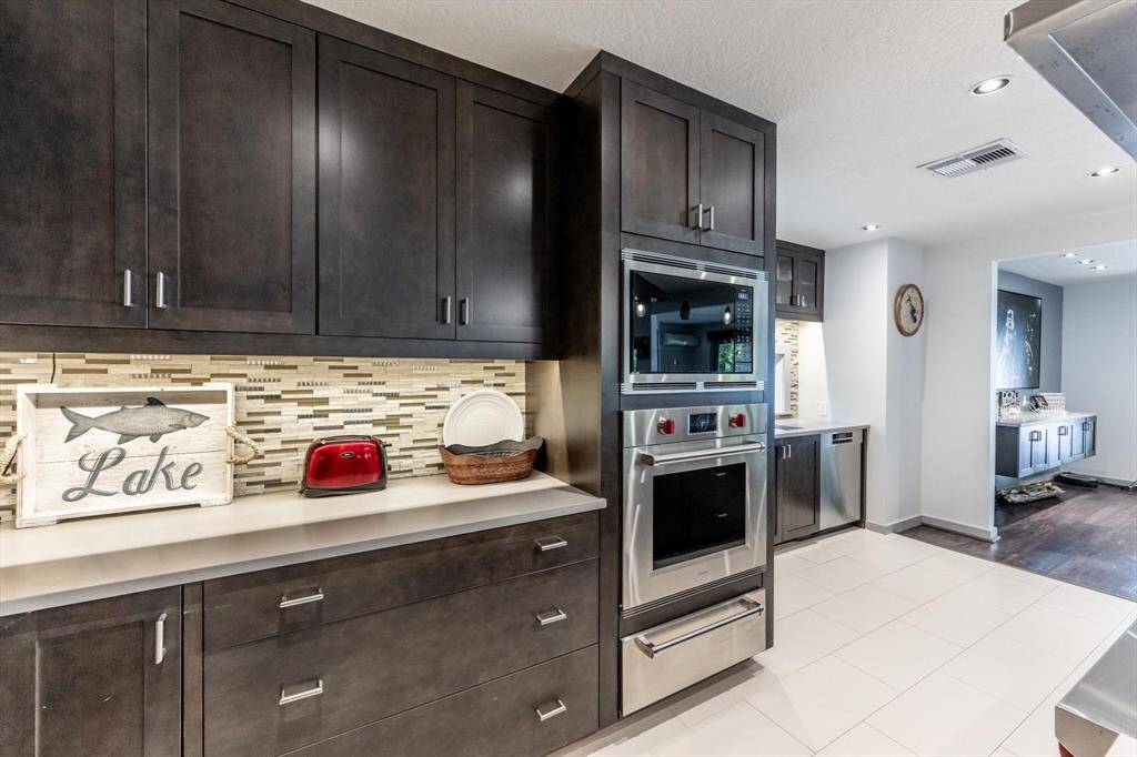 Sleek sophistication meets everyday function in this stunning kitchen with top of the line Wolf-Subzero & Bosch appliances.