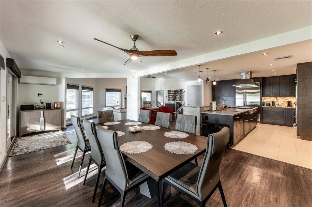 The expansive open-concept space seamlessly blends modern luxury with warm hospitality. The elegant dining area flows seamlessly into the living area and outside patio.