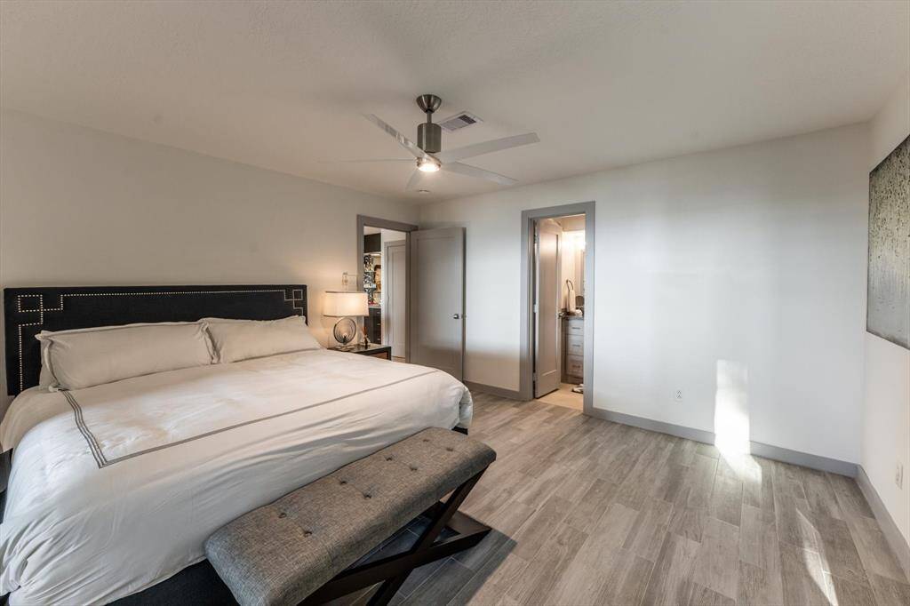 Another view of the guest suite shows off its spacious layout, calming tones, and en-suite bath—perfect for visitors who like their privacy with a touch of luxury.