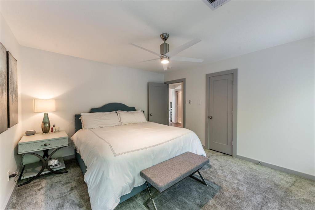 This awesome guest room delivers cozy comfort with plush carpeting, soft neutral tones, and easy access to the shared bath—perfect for restful nights and relaxed mornings.