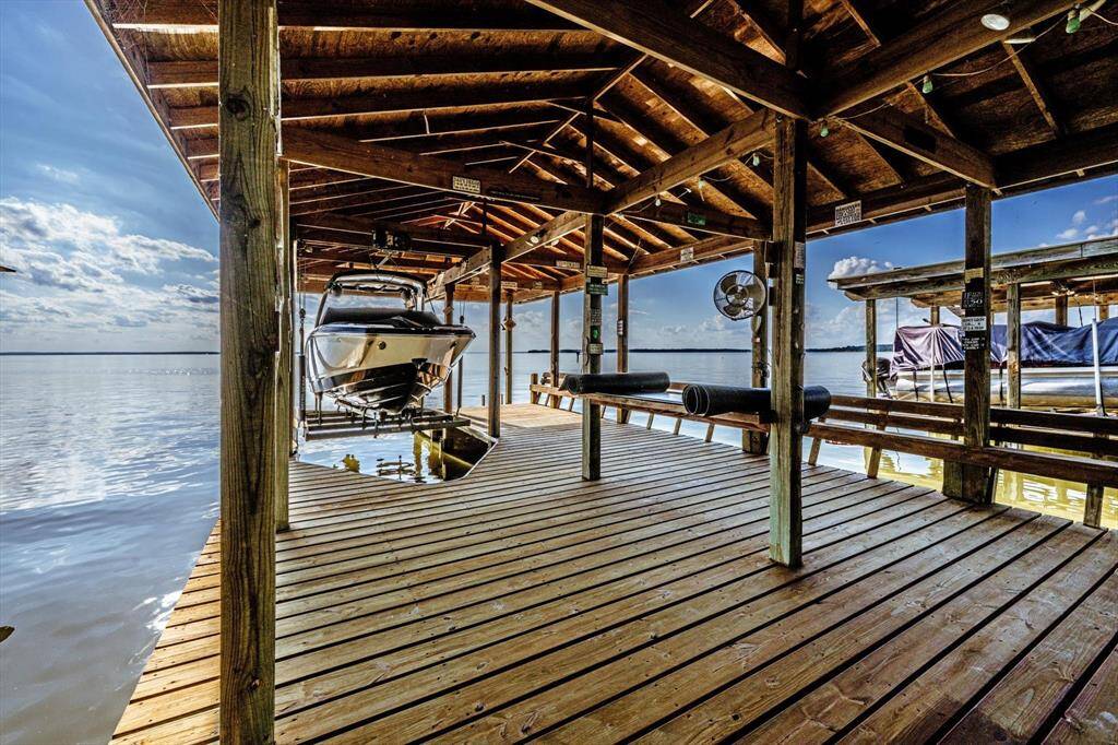 This custom boathouse features a covered lift built to accommodate up to a 27' boat—lake living, elevated.