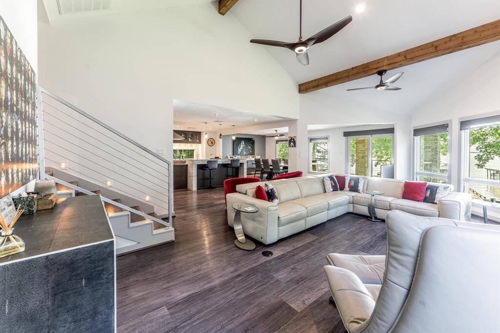 With tall ceilings, an open floor plan with living area open to dining and kitchen,and a wall of windows showcasing the lake, this home is absolutely gorgeous and perfect for entertaining!
