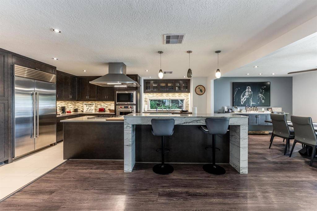 The gourmet kitchen is a chef's dream and no detail was left unnoticed when this kitchen was remodeled in 2018...Wolfe gas cooktop features 6 burners and griddle, Sub Zero Fridge, 2 sinks, Bosch Dishwasher Custom Cabinets!  A true Chefs Delight!