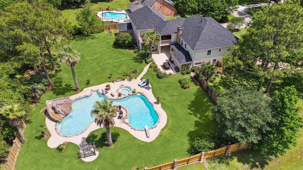 Here's an aerial view of your 55,000 gallon heated pool/spa with a rock waterslide. You have plenty of room to entertain and run around.