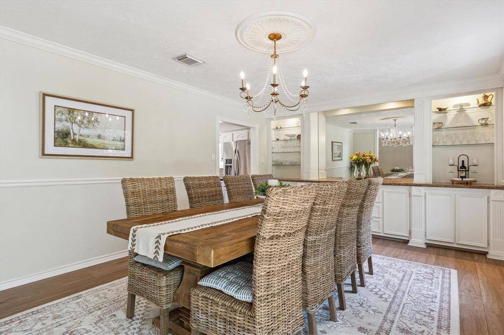 The formal dining room is just off the entry and it features a wall of built-ins so you have the perfect serving area and room to store your china and barware. This makes an excellent dry bar too.