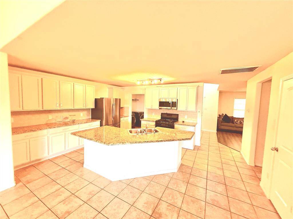 Kitchen with oversized island with sink