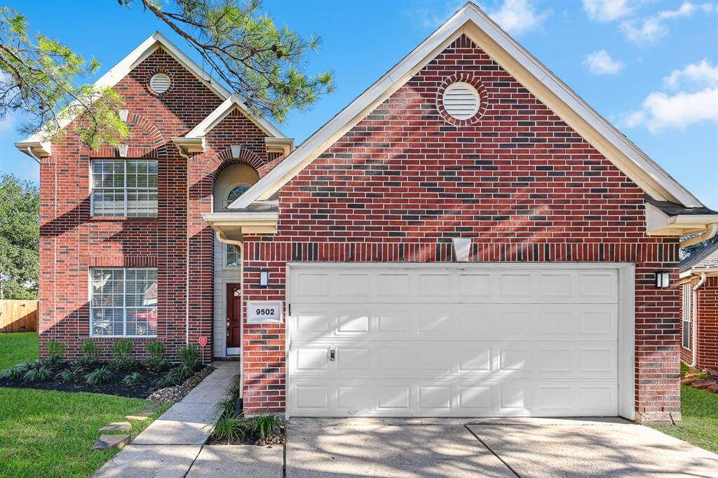 Charming brick home featuring a spacious two-car garage and a welcoming front entry. Surrounded by lush greenery, this property offers a perfect blend of style and comfort.