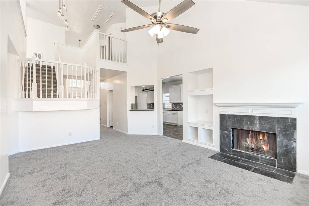 Experience modern comfort in this inviting home featuring a spacious living area with vaulted ceilings and a cozy fireplace. The open layout seamlessly connects to a stylish kitchen, perfect for entertaining. Enjoy the elegant blend of contemporary design and warm ambiance.