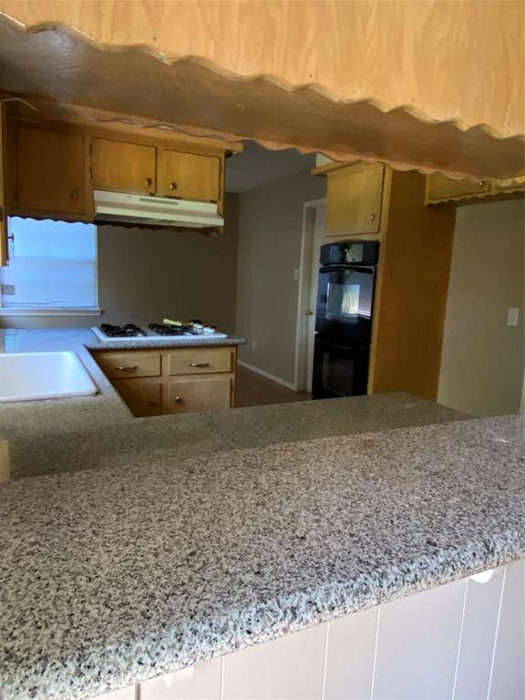 View of kitchen from bar area