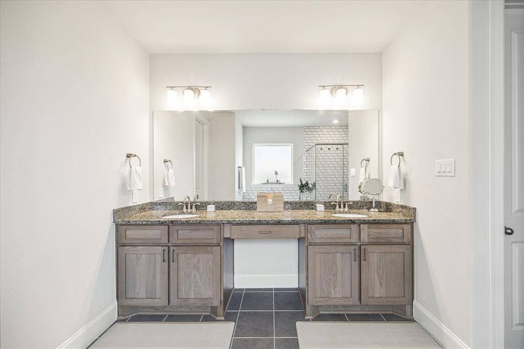 Dual vanities in primary bath with the all important knee space for getting ready.