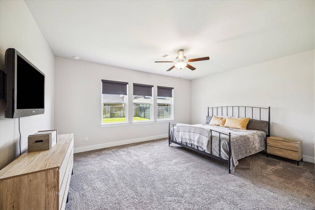 Primary bedroom is large enough to accommodate a king bed, nightstands, all your furnishings and still have plenty of space to relax.  The room here is upgraded with motorized blackout shades that are also wifi enabled.