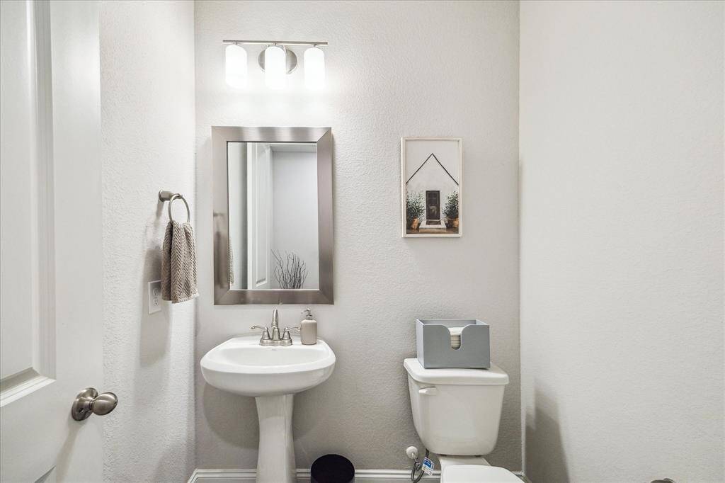 Upgraded half bath option was chosen to accommodate all guests without having to use a secondary bathroom. Simple and transitional in style, the half bath is located close to the kitchen and flex room.