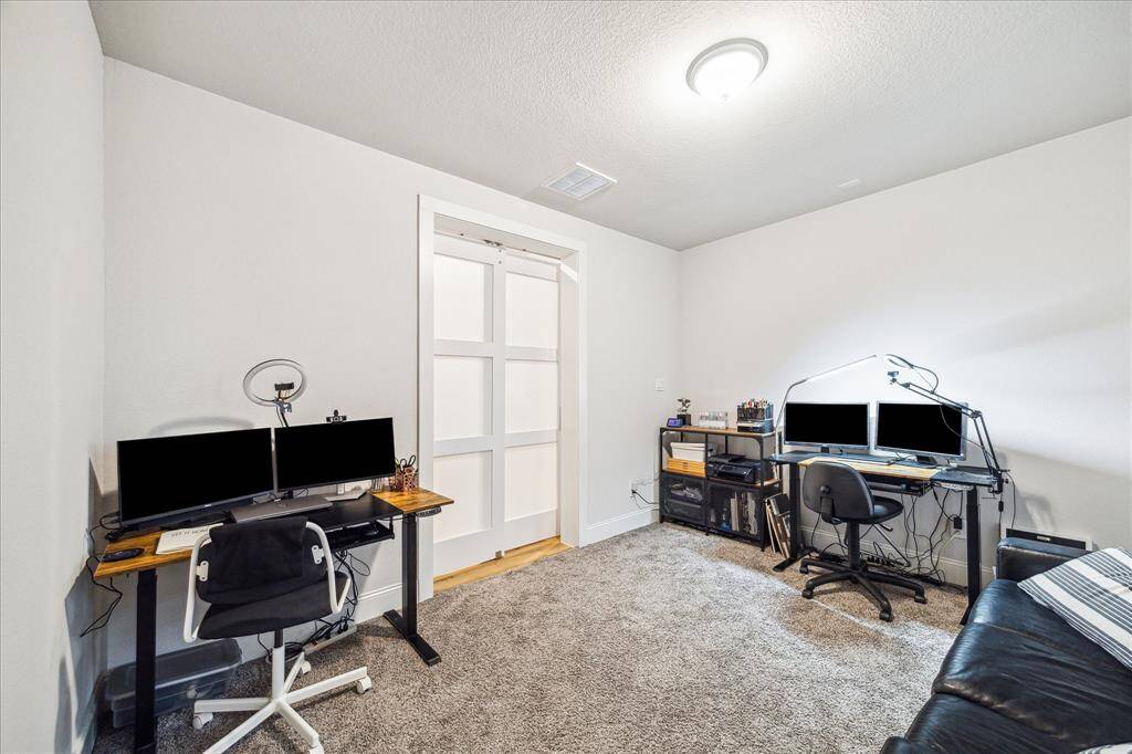 Study shown here with collaborative partner set up. Sliding, paneled door with frosted privacy glass maximizes usable space in the room.  The room is equipped with blackout shades for improved on-line meeting conditions.