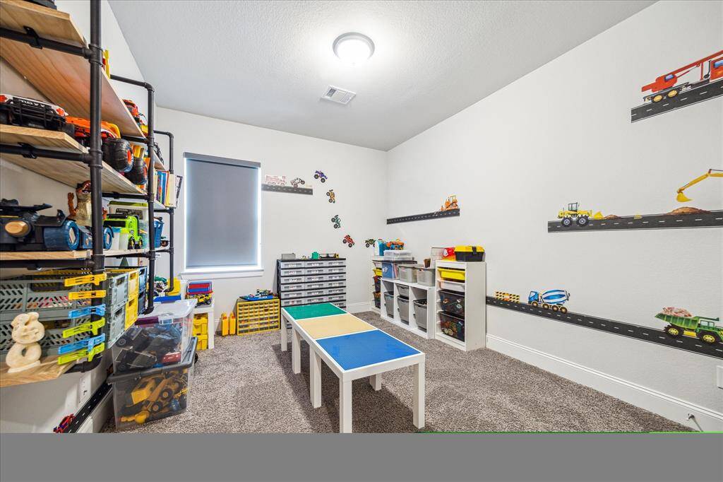 Secondary bedroom currently being used as a kids' imagination room.  Blackout shades in both secondary bedrooms on this side of the home.